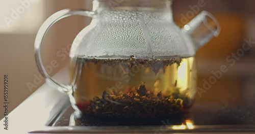 tea is brewed in a glass teapot, evaporation drops on the walls of the teapot