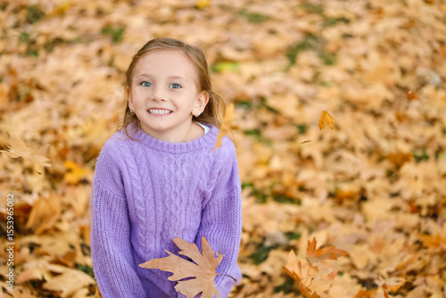 Cute little happy girl thro...