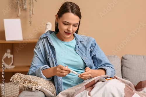 Young diabetic woman taking...