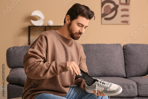 Young man putting black ort...