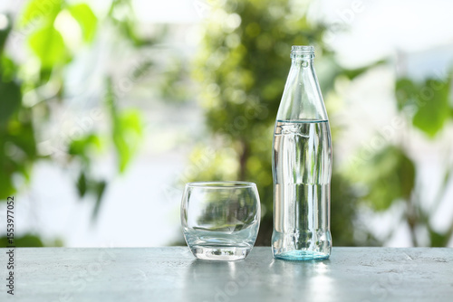 Glass and bottle of water o...