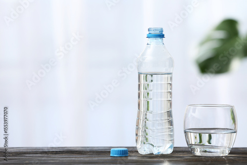 Bottle of water and glass o...