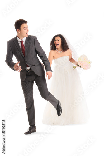Young wedding couple runnin...