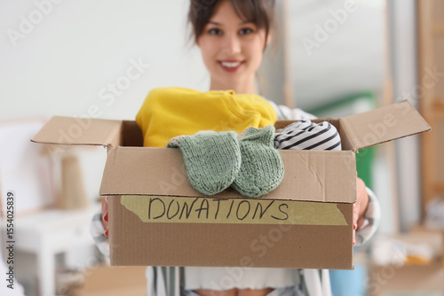 Young woman holding box wit...