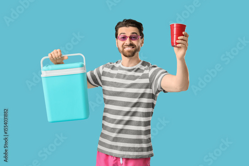 Happy young man with portab...