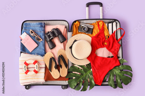 Open suitcase with clothes,...
