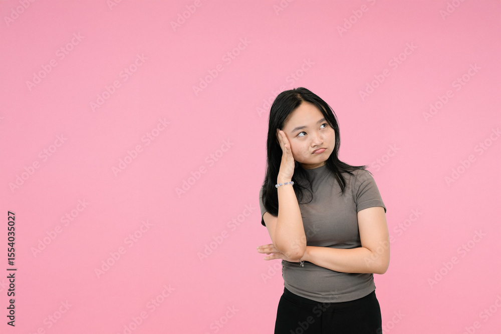 young asian woman showing dissapointed in studio background young asian woman showing dissapointed in studio background