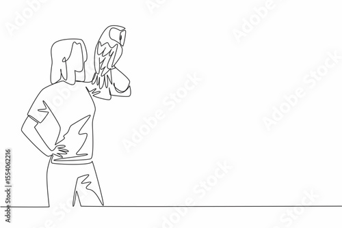 Single one line drawing tawny owl perched on hand of woman. Medium sized owl that lives in England. One of the favorite animals to keep. Woman Holding Bird. Continuous line design graphic illustration