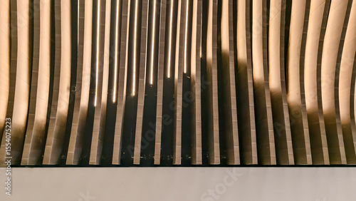 Contemporary wall with vertical wood slats creating dynamic shadows and light interplay