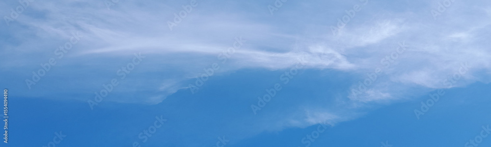 Clear blue sky with thin, wispy white clouds gently stretching across the horizon, creating a calm and peaceful daytime atmosphere. Clear blue sky with thin, wispy white clouds gently stretching across the horizon, creating a calm and peaceful daytime atmosphere.