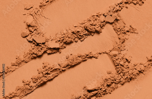 Powder texture. Eyeshadow, bronzer, blush swatch. Brown makeup powder background