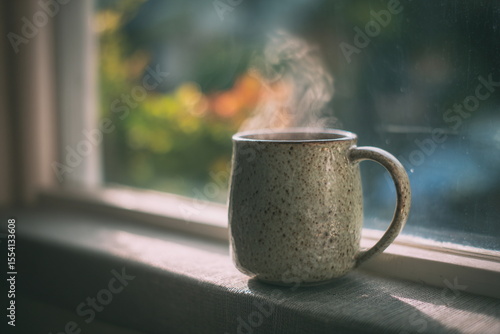 Wallpaper Mural Rustic cup of hot drink with steam rising, standing on a windowsill in soft daylight, evoking a sense of relaxation, peace and cozy home moments Torontodigital.ca