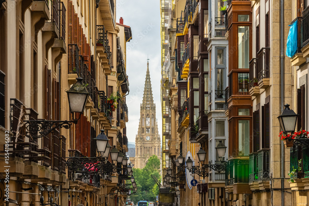 Obraz premium Main street in the old town of San Sebastian with the cathedral of the Good Shepherd in the background, Basque Country.