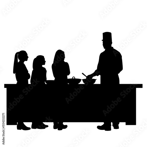 Students observing chef during cooking class in kitchen, culinary arts