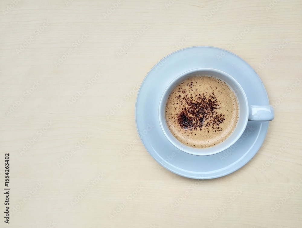 Fototapeta premium Cappucino coffe in glass on wooden table background. Flat lay, copy space 