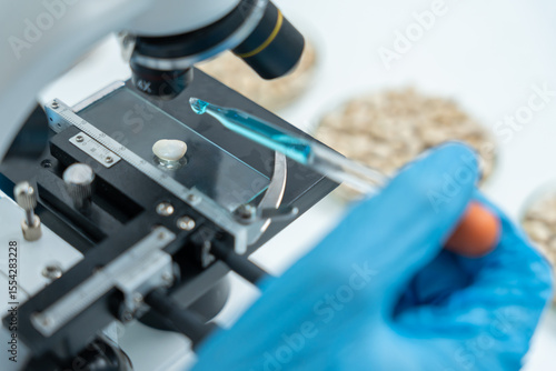 Scientist analyze biochemical samples in advanced scientific laboratory. Medical professional use microscope look microbiological developmental of viral. Biotechnology research in science lab.