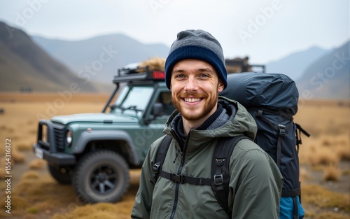 Wallpaper Mural Portrait of a young traveler man in hiking equipment standing near his off-road car. High quality Torontodigital.ca