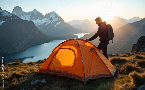 Man setting up tent camping gear in mountains travel hiking outdoor in Norway adventure active vacations healthy lifestyle extreme tour climbing equipment. High quality