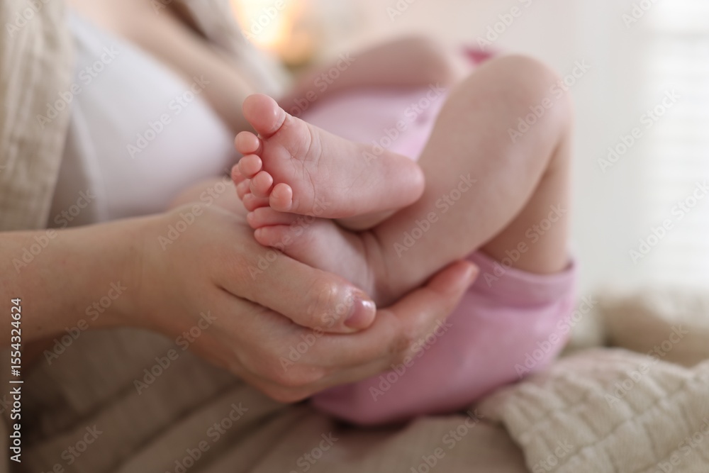 Mother with her newborn baby indoors, closeup Mother with her newborn baby indoors, closeup