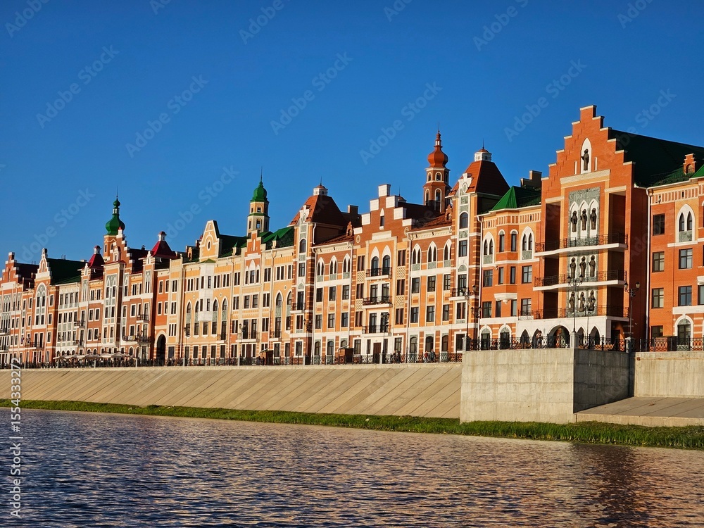 Fototapeta premium Row of buildings with a green roof. The buildings are red and white in Yoshkar-Ola - capital of the Republic of Mari El in Russia