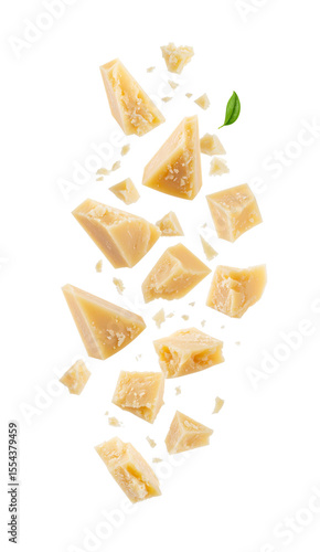 Parmesan cheese pieces falling with basil leaf on transparent background