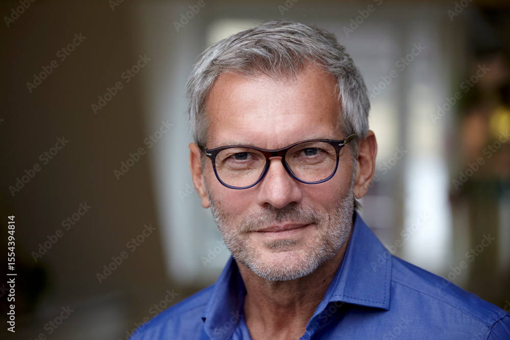 Portrait of a mature man with glasses smiling indoors Portrait of a mature man with glasses smiling indoors