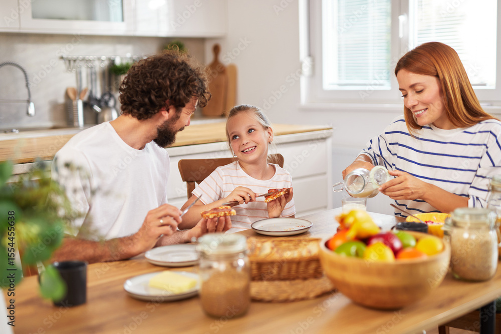 A family is gathered around a wooden kitchen table, sharing food and laughter. The atmosphere is joyful as they connect over a casual meal filled with light and happiness. A family is gathered around a wooden kitchen table, sharing food and laughter. The atmosphere is joyful as they connect over a casual meal filled with light and happiness.