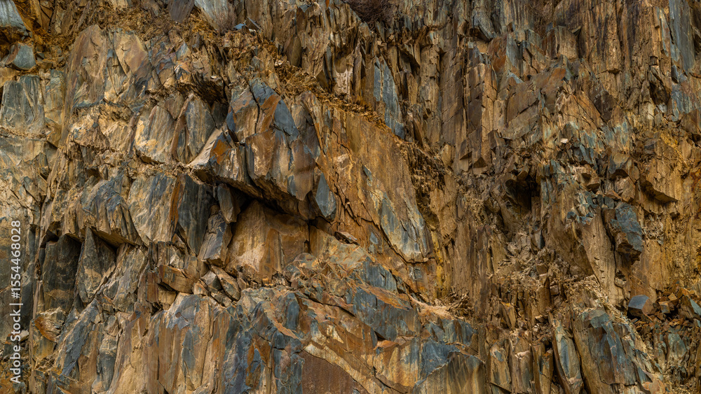 Fototapeta premium Rugged brown sedimentary cliff, full-frame closeup