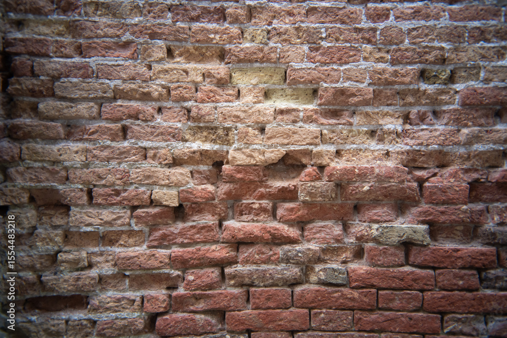 Obraz premium Textures of time revealed in a weathered brick wall from a vintage perspective