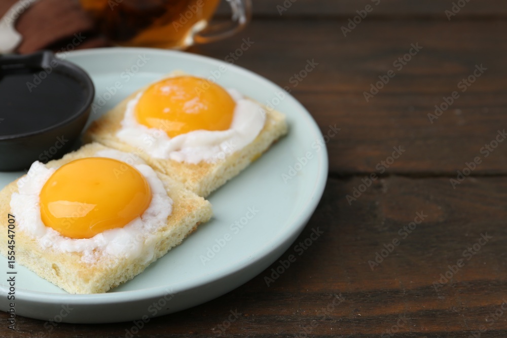 Traditional asian breakfast with tasty kaya toasts and half-boiled eggs served on wooden table, closeup. Space for text Traditional asian breakfast with tasty kaya toasts and half-boiled eggs served on wooden table, closeup. Space for text