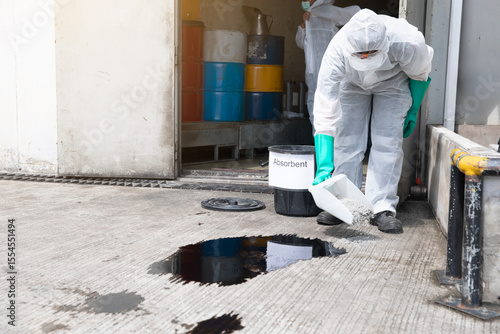 Worker in Hazmat Suit Treating Industrial Chemical Spill