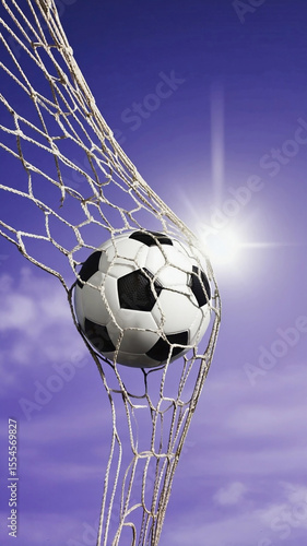 Soccer ball scoring a goal in the net with a bright sun flare