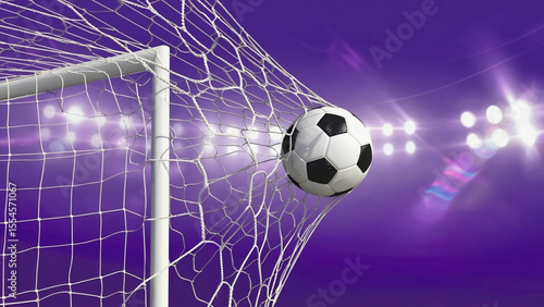 Soccer ball in the net during a night game with stadium lights
