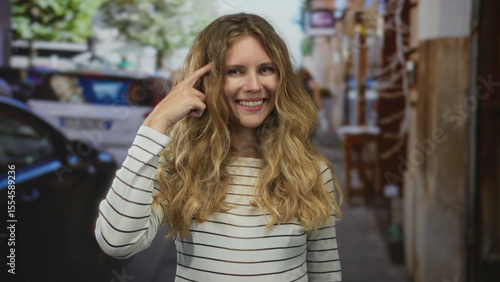 Wallpaper Mural Woman head pointing idea thinking concept shown by blonde young subject standing on street urban scene. Torontodigital.ca