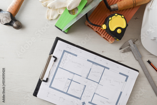 Foto General view of architect's desk with folder with plans