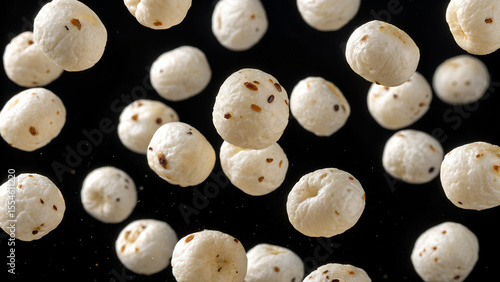 Wallpaper Mural Puffed makhana or fox nuts levitate against a dark backdrop in a studio shot Torontodigital.ca