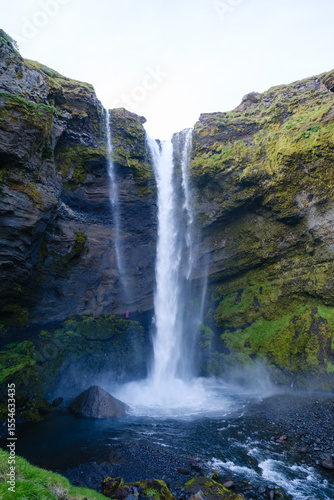 Majestic Kvernufoss waterfall cascading in the scenic landscape of Iceland