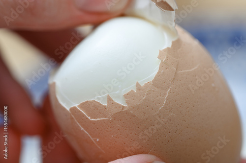 Plakat w ramie Peeling a hard-boiled egg from its shell