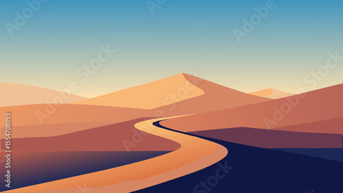 Winding desert road through sand dunes under a clear blue sky
