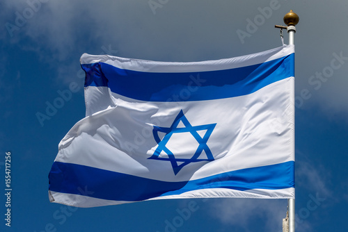 Large Israel flag waving in the wind. Israeli flag for advertising, holidays, achievements, festivals, elections. The Israeli flag flutters in the beautiful sky. Great for news.