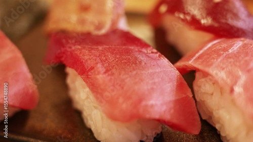 Fresh tuna nigiri sushi pieces on a serving plate.