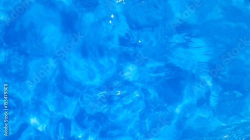 Blue water movement with top view into the pool. Relax background and texture.