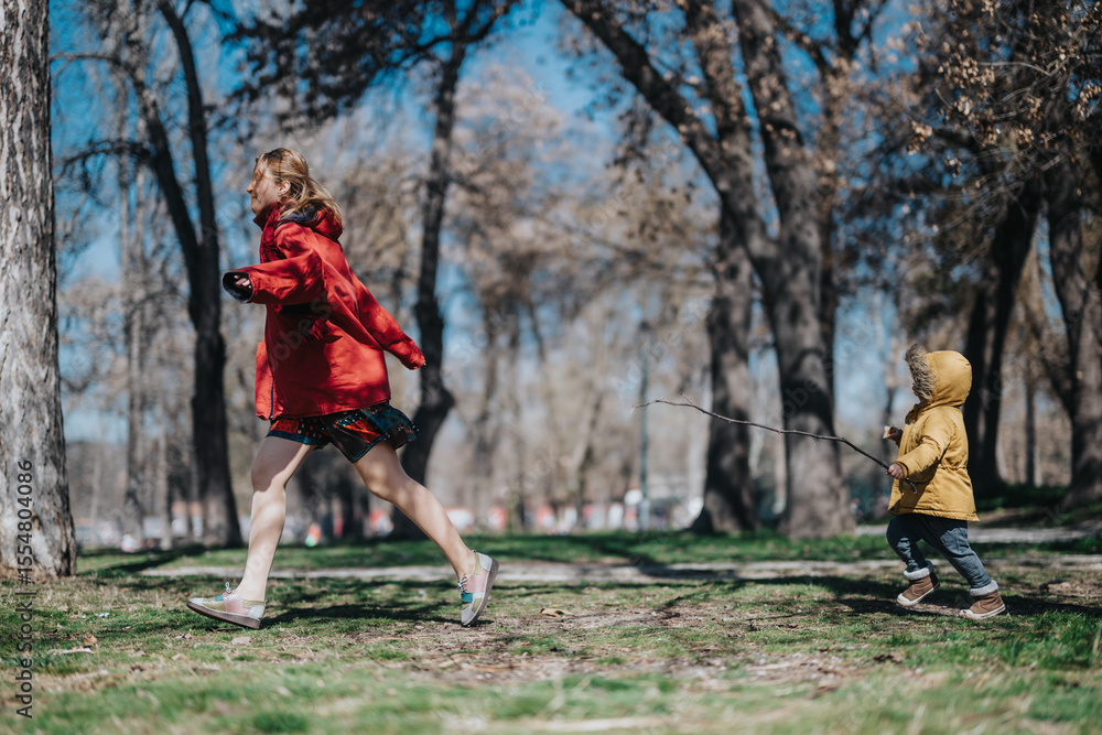 Fototapeta premium A cheerful mother and her excited child running together through a sunlit park, surrounded by trees and a serene atmosphere. Perfect image capturing the joy of family and nature.