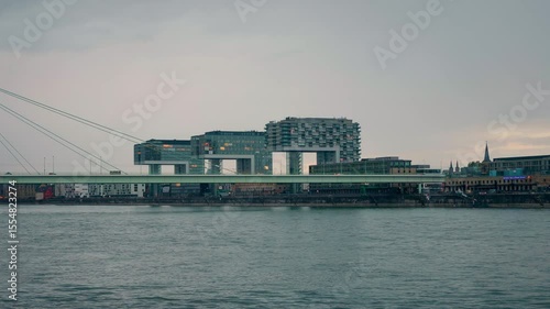 Severinsbrucke bridge with Crane Houses in the background at dusk in Cologne, Germany.