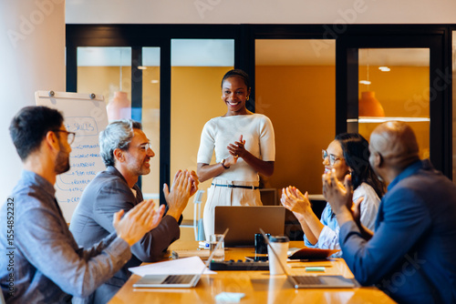 Fotografie Confident professional leading a discussion in a team meeting setting