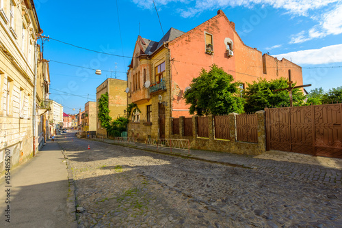 Wallpaper Mural uzhhorod, ukraine - 11 jun 2017: european urban landscape with street of town in morning light. cobblestone path down the hill to koriatovycha square in city center Torontodigital.ca