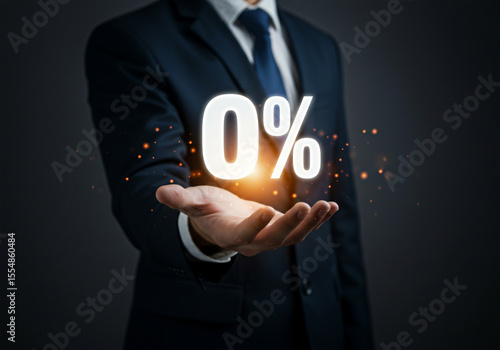 Businessman holding zero percent glowing symbol with sparks