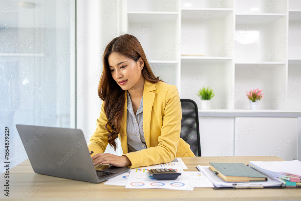 A businesswoman is working in her office. She is checking documents at her desk with a calculator and a mobile phone. She is looking at the calculator and thinking.
A businesswoman is working in her office. She is checking documents at her desk with a calculator and a mobile phone. She is looking at the calculator and thinking.