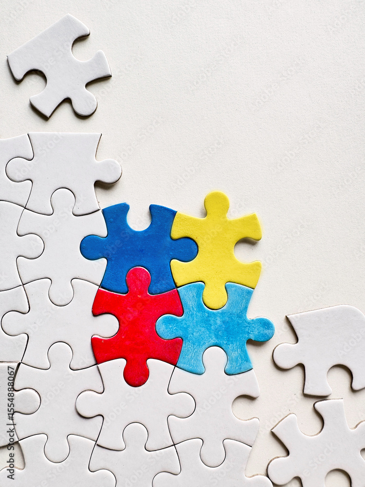Colorful puzzle pieces symbolizing Autism Awareness Day on a white background Colorful puzzle pieces symbolizing Autism Awareness Day on a white background
