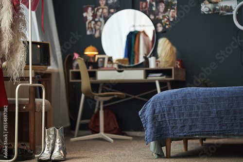 Fotografie Creative Gen Z girl bedroom showing workspace with vanity mirror, clothing rack,